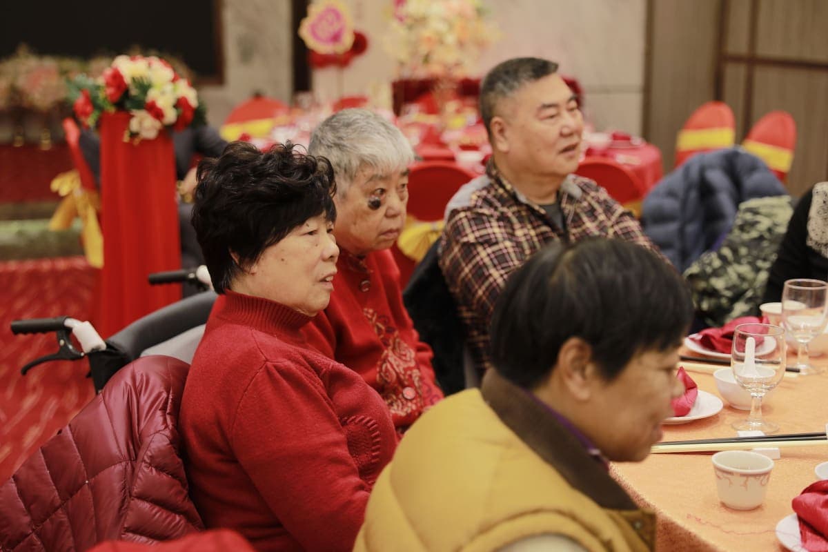 A family seated together around a festively decorated dining table during a celebration meal