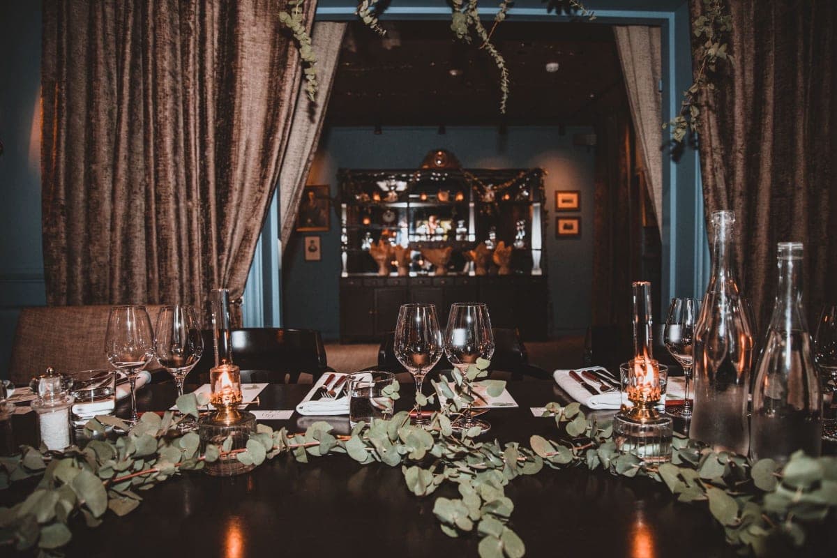 A set table in a European restaurant dining room in the evening