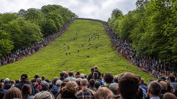 Cheese Rolling Festival 2027 crowds on the steep slope of Cooper's Hill in Gloucestershire